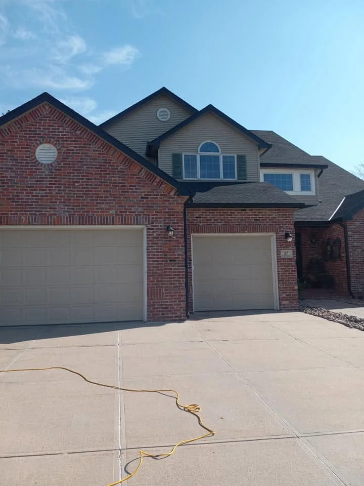 Two-story brick house with new gutters along the roofline